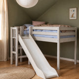 FLEXA WHITE high bed with slide and safety rail from CLASSIC in green kids’ room, wood floor, sunlit and child-safe.